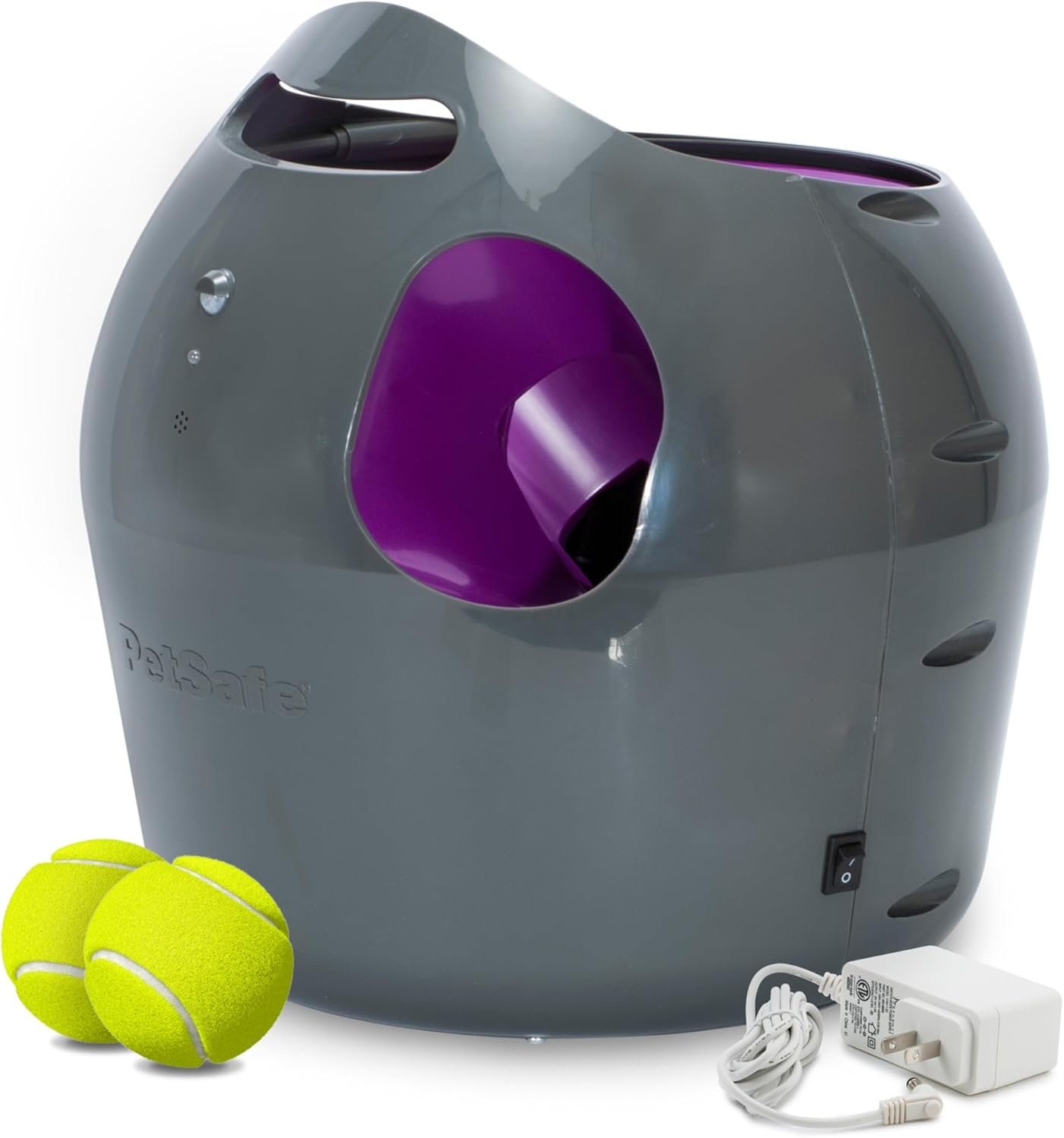 Best automatic ball launcher: the PetSafe launcher with two tennis balls and its power adapter